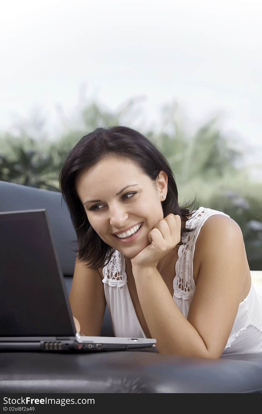 Portrait of woman with laptop in summer environment. Portrait of woman with laptop in summer environment