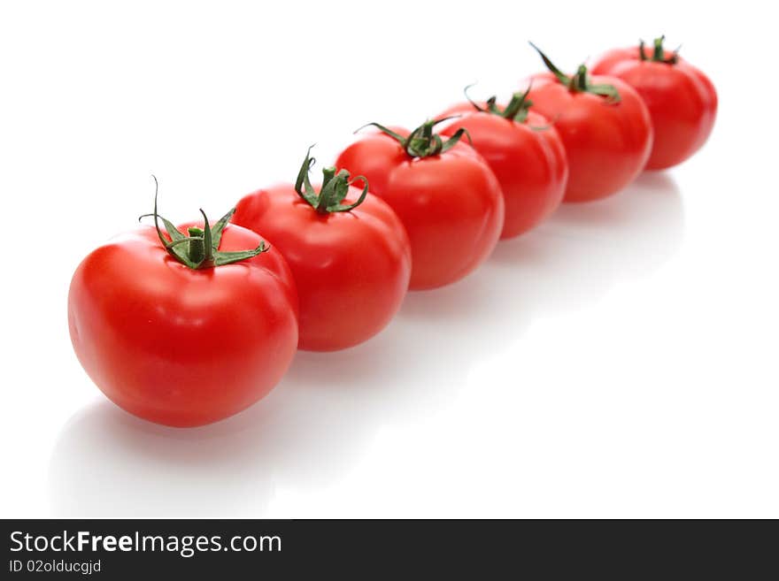 Red tomatoes on a white background, it is isolated. Red tomatoes on a white background, it is isolated.