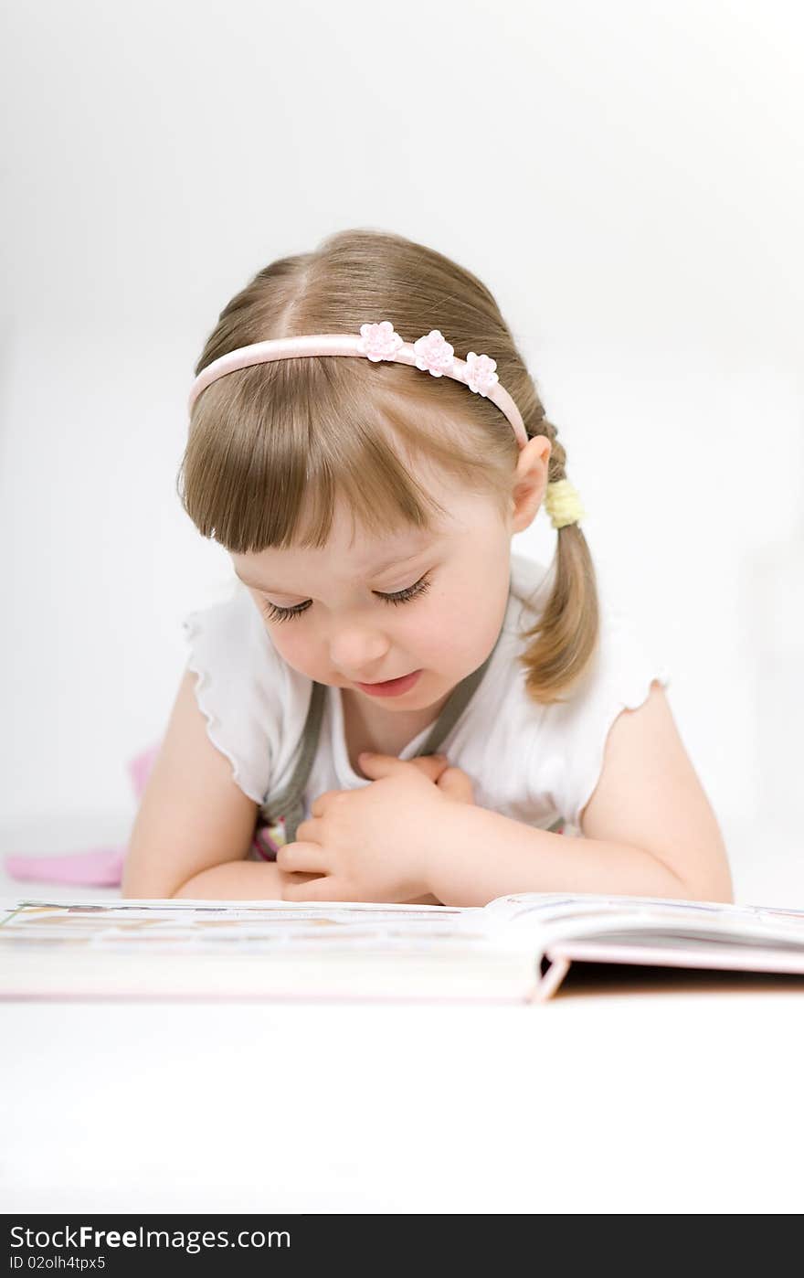 Little girl reading book