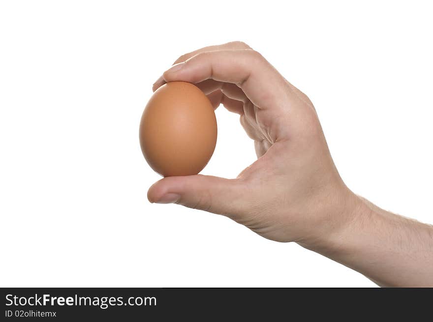 Well shaped men's hand with an egg isolated over white