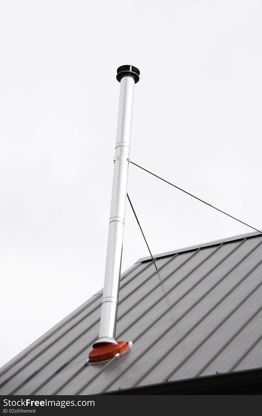 A wood stove pipe chimney on a residential home.