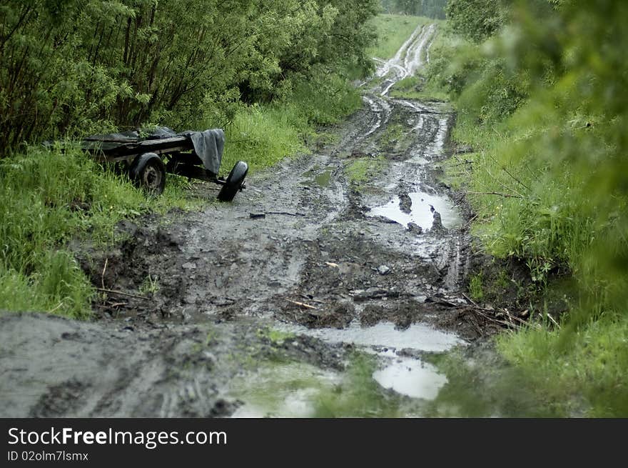 Old broken waggon on abandoned countryside road.