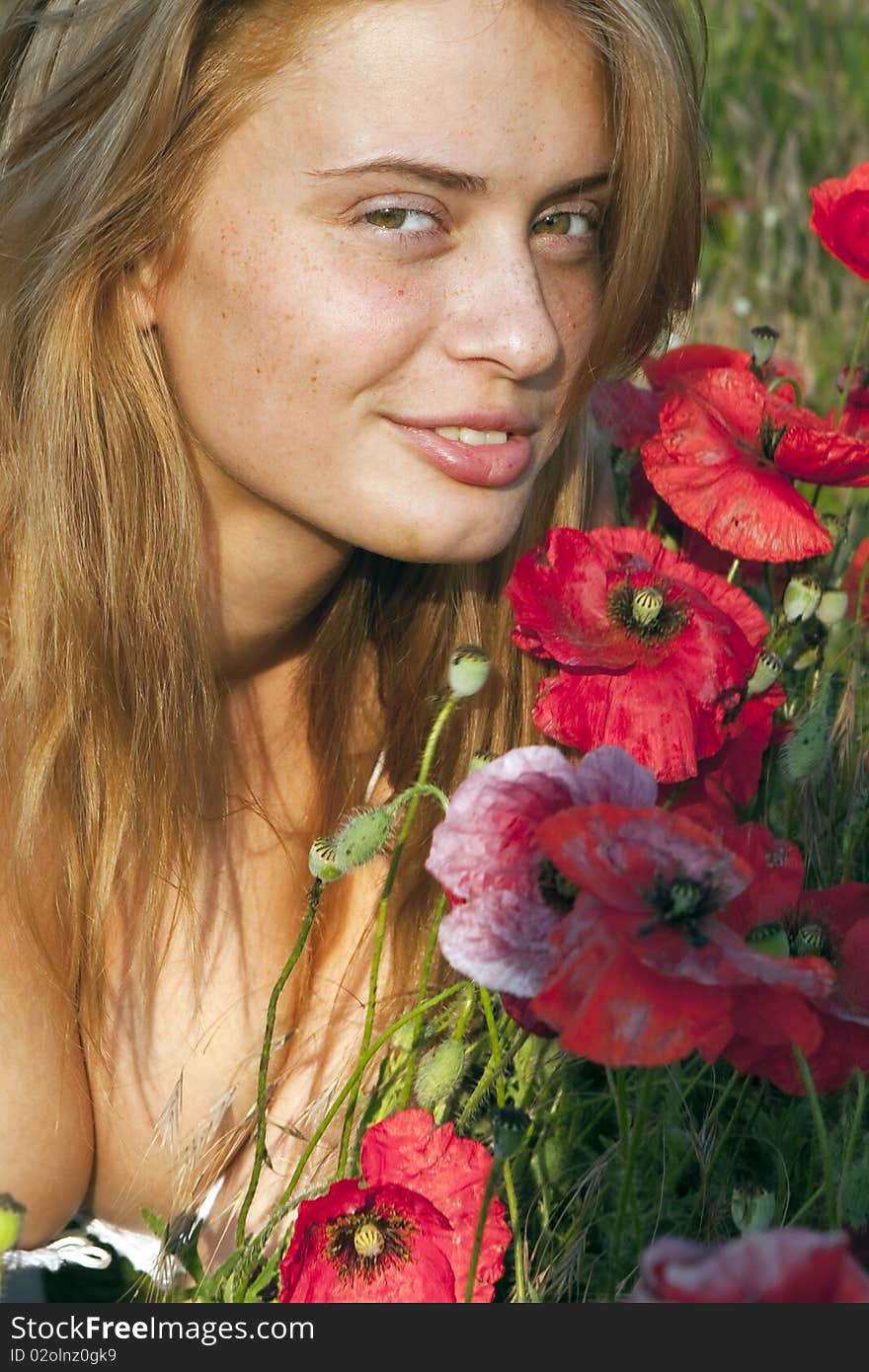 Portrait of a beautiful girl in the red poppies