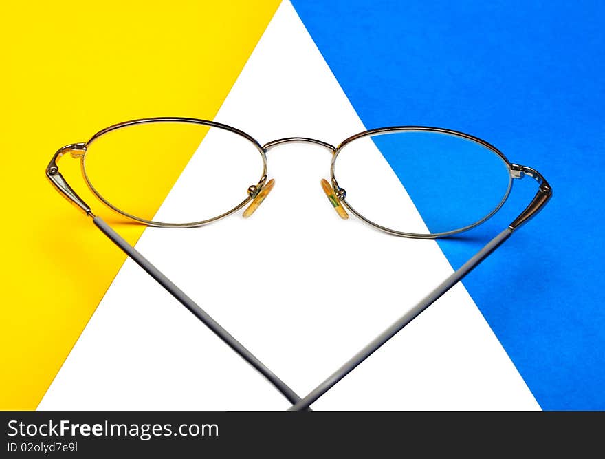 Glasses for eyes on blue and yellow background