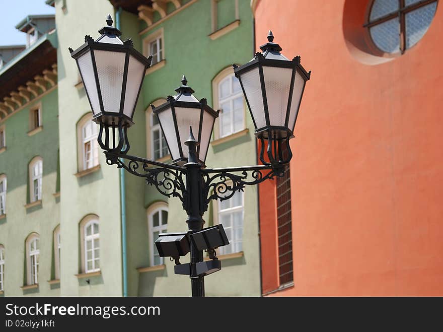 Street lamp in front of the wall of green brick