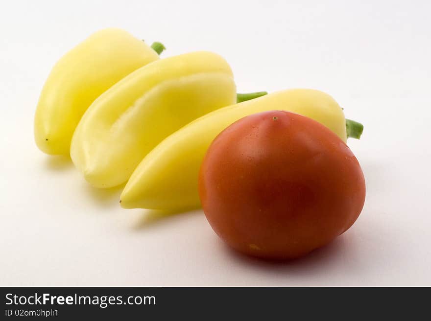 Fresh tomato and sweet peppers on a white background. Fresh tomato and sweet peppers on a white background