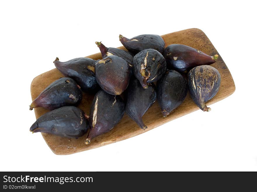 Ripe higos on wooden plate in isolated over white