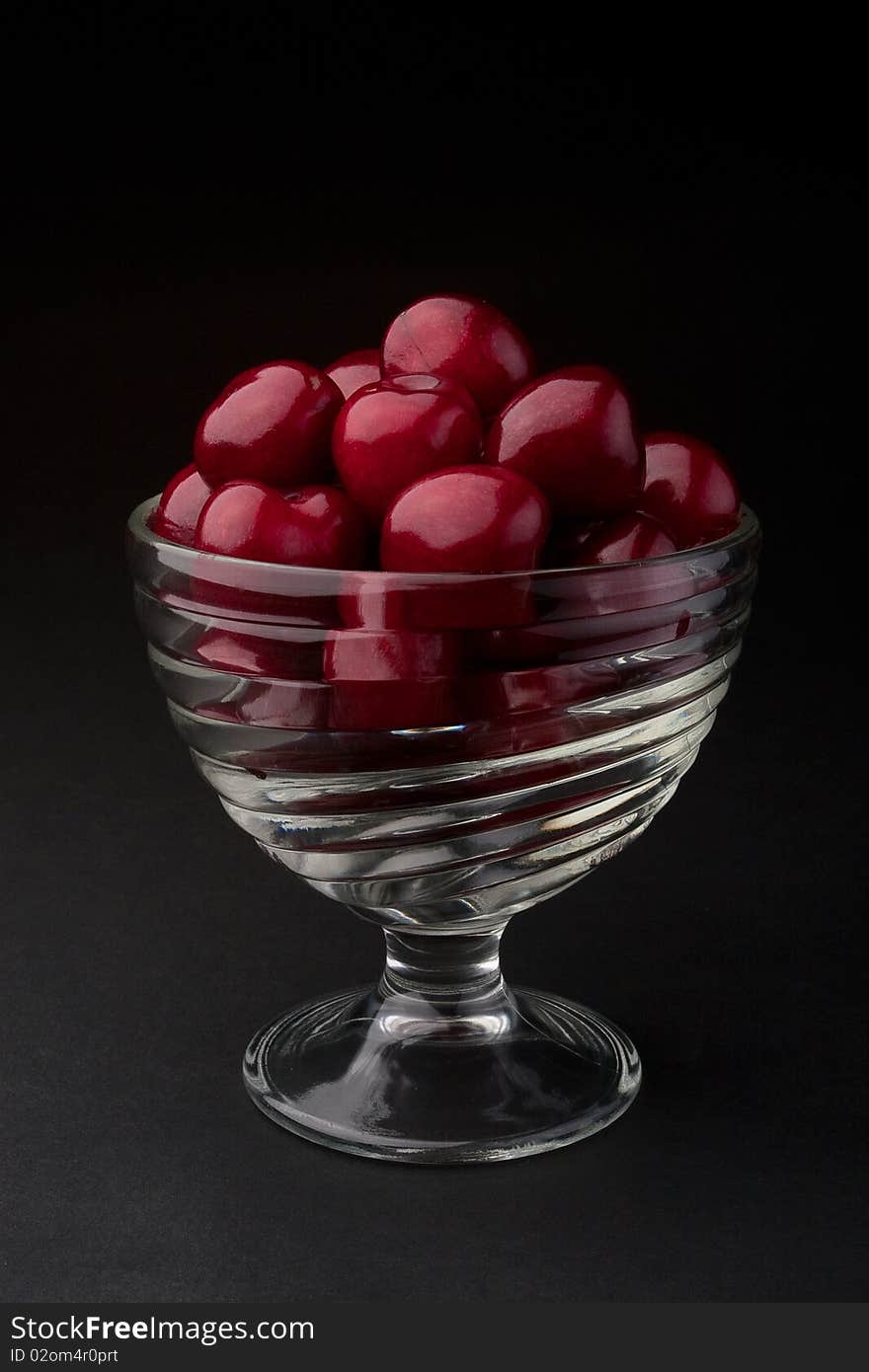 Cherries in a bowl on a black