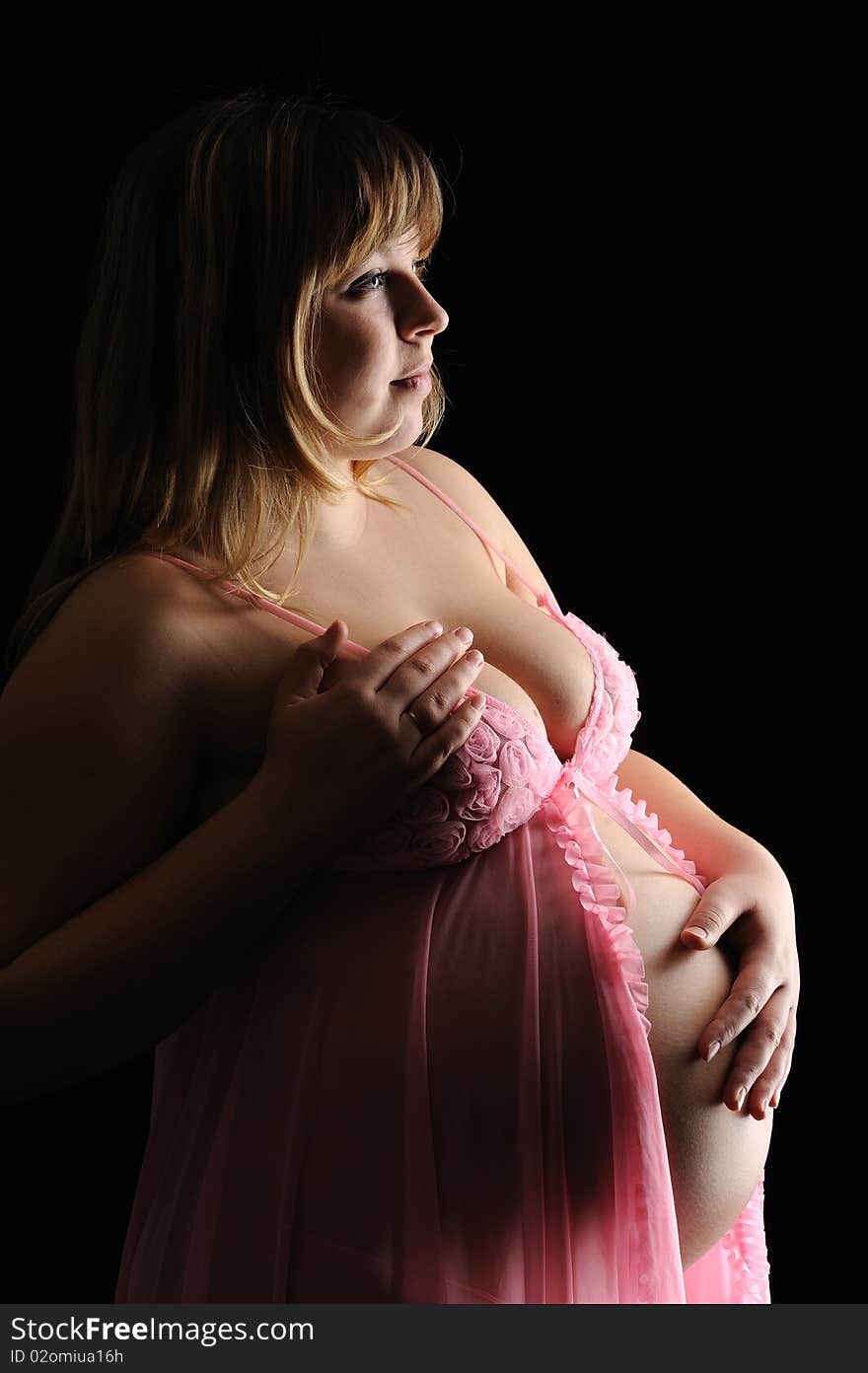 Pregnant woman on a black background