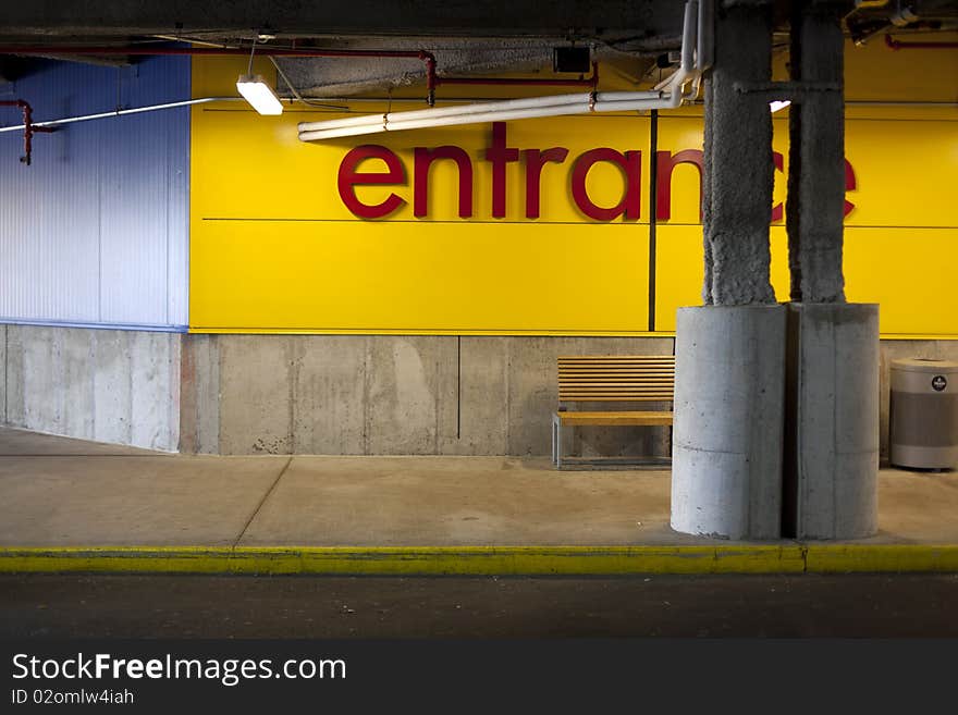 Yellow curb by the store entrance illuminated by fluorescent lights