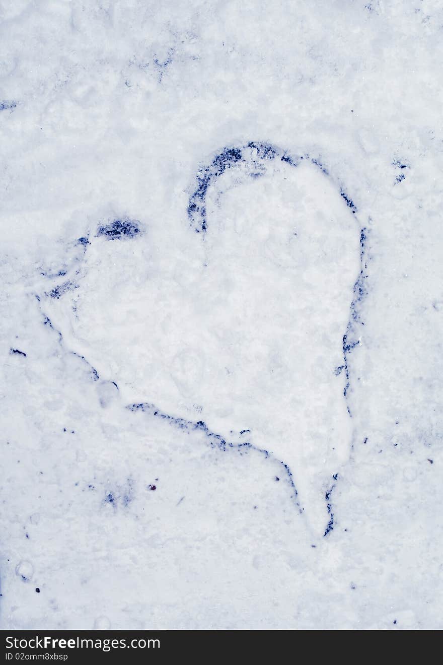 Heart on asphalt in snow