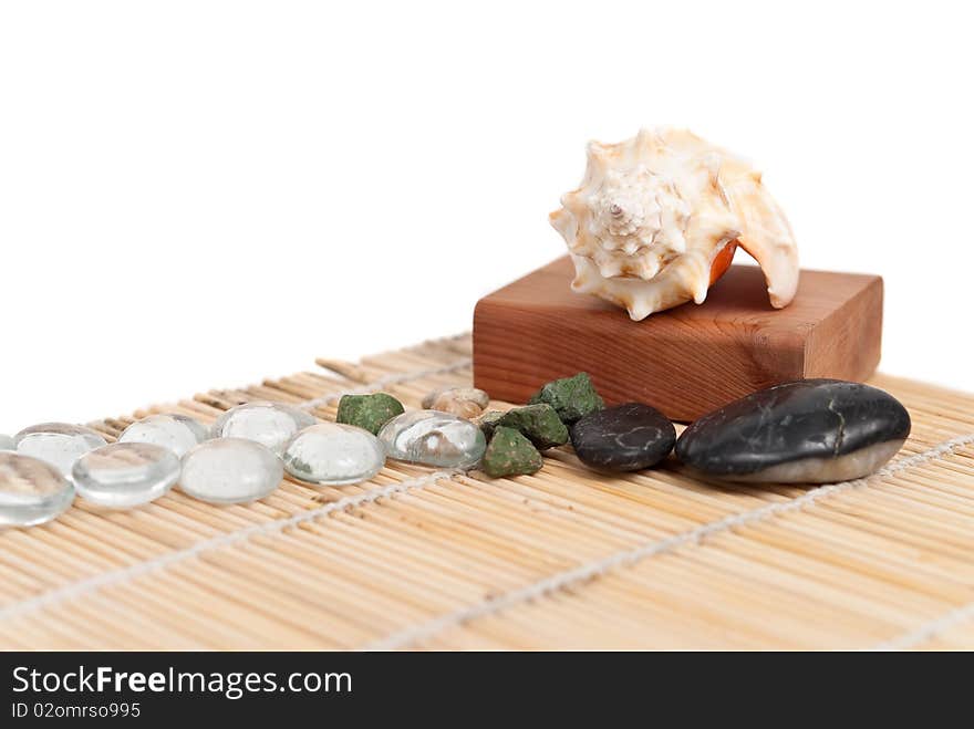 Shells, stones and pebbles on a bamboo mat. Shells, stones and pebbles on a bamboo mat