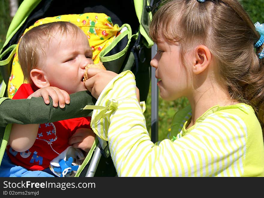 Elder sister gives to the brother ice-cream. Elder sister gives to the brother ice-cream