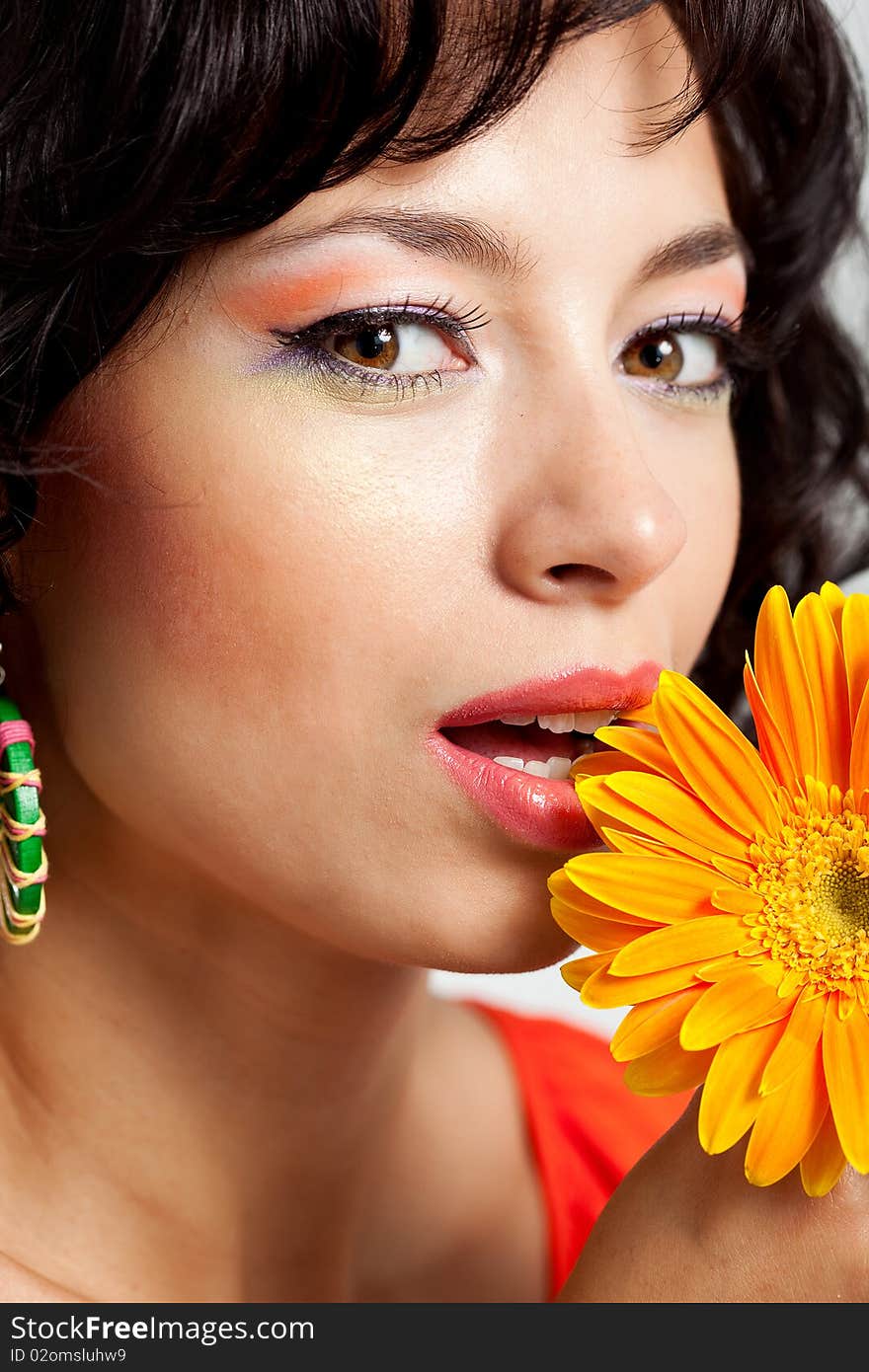 Beautiful woman with flower at studio