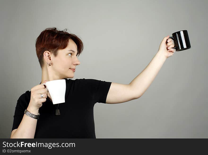 A girl with two cups, black and white. A girl with two cups, black and white