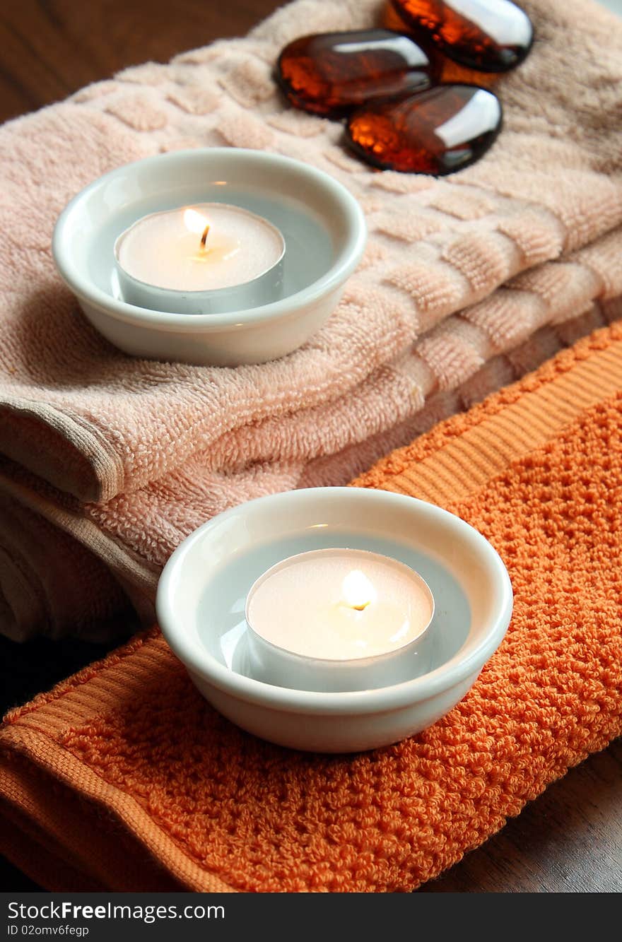 Spa candles on towels