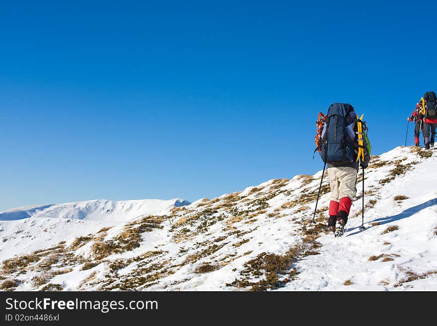 Hiker in winter in mountains