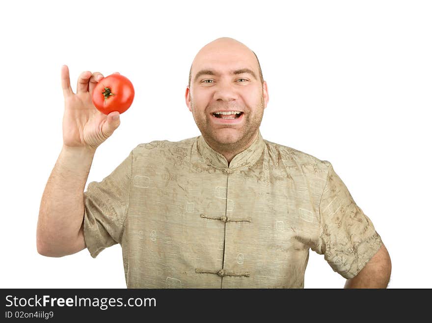 The smiling man holds a tomato on a white background