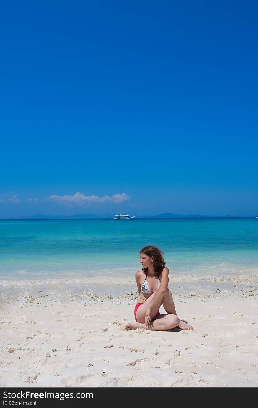 Woman doing yogastic exericise on the beach