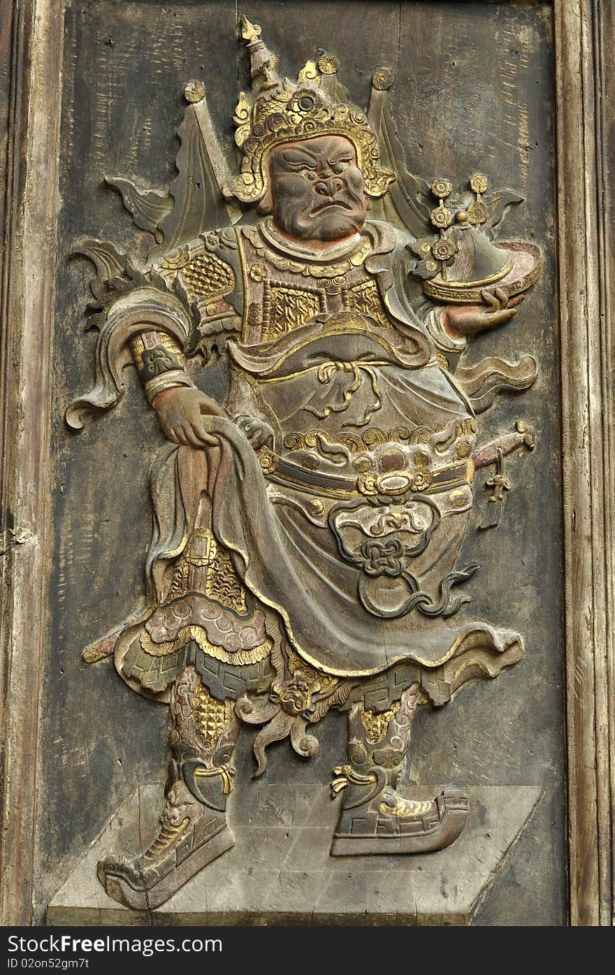 Image of a deity on a Chinese temple door. Image of a deity on a Chinese temple door.