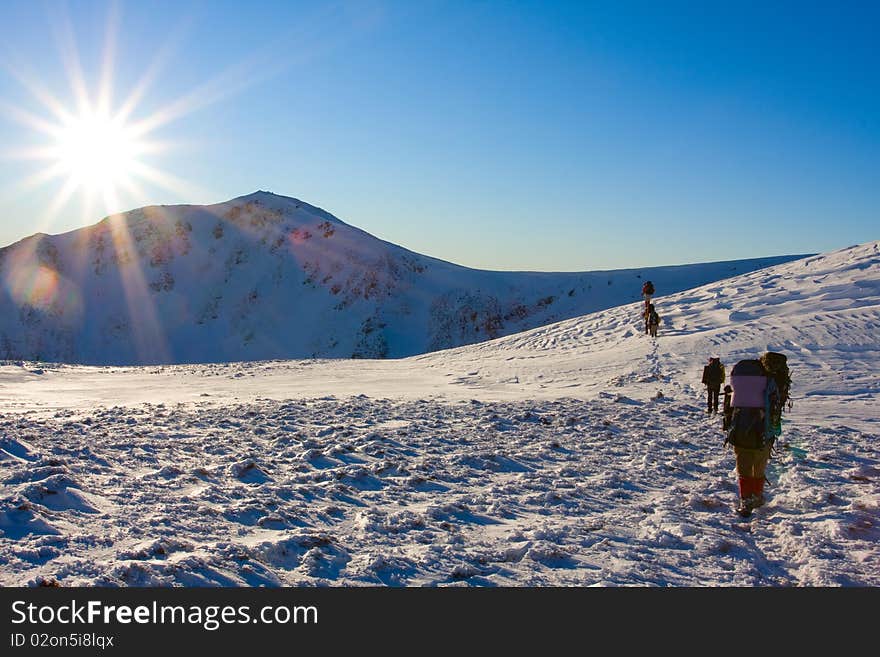 Hiker in winter in mountains