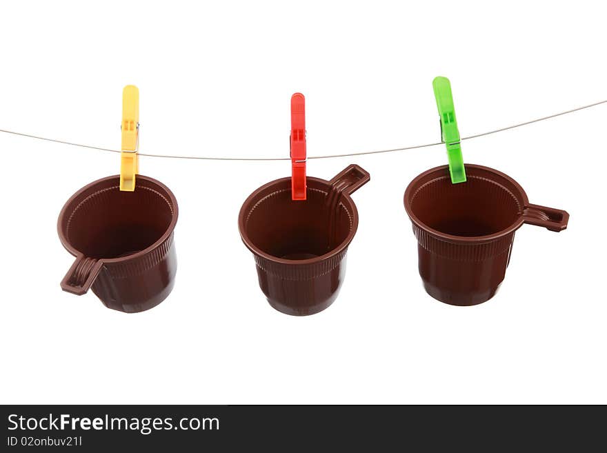 Plastic glasses hang on clothespins is isolated on white a background