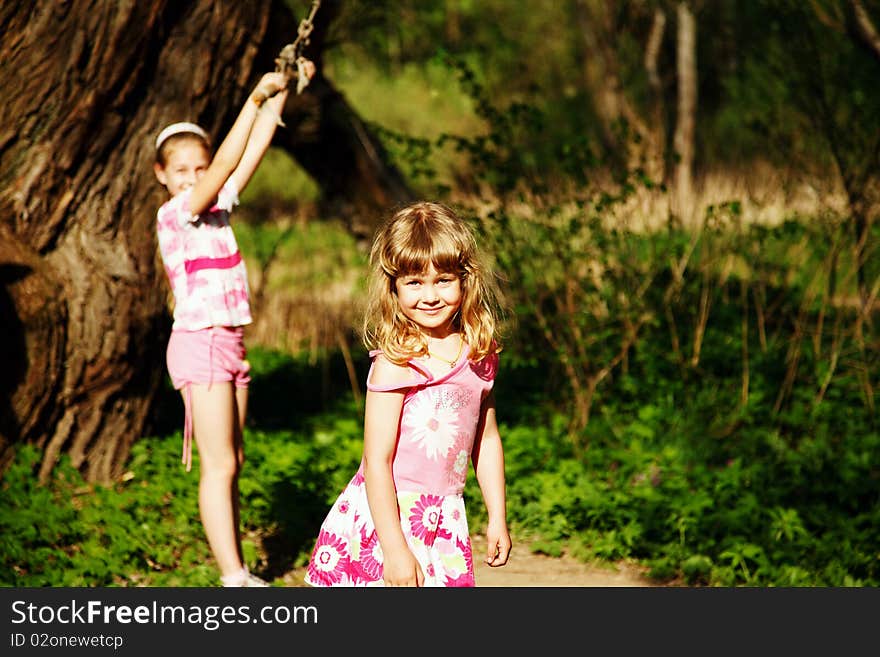 Two smiling girl in pink clothes