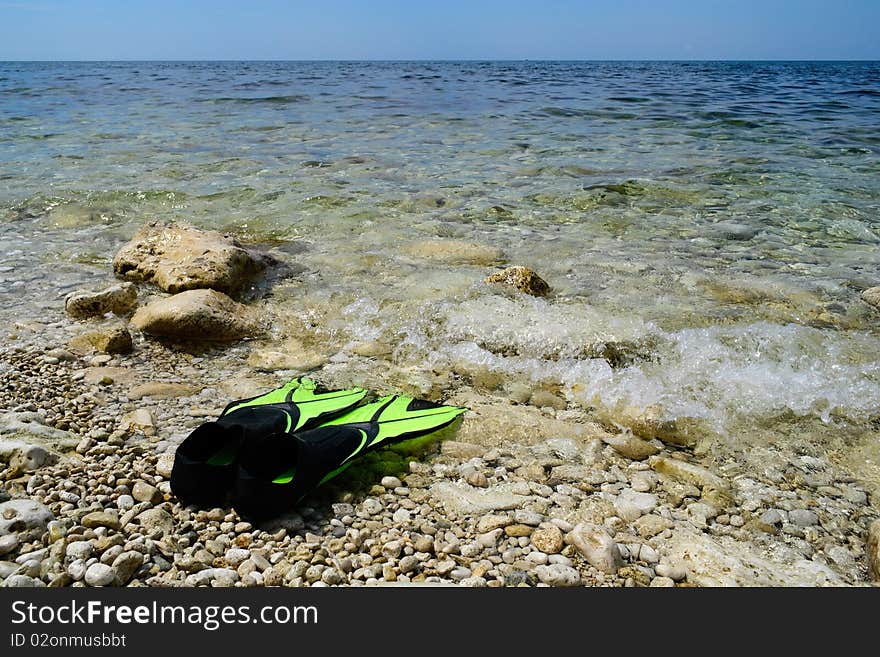 Scuba snorkeling green flippers set at seaside. Scuba snorkeling green flippers set at seaside