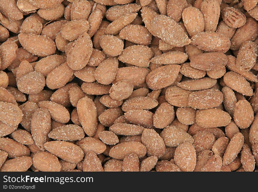 Background of salted and roasted almonds. Background of salted and roasted almonds