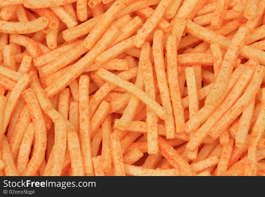 Background of orange cheese puffs