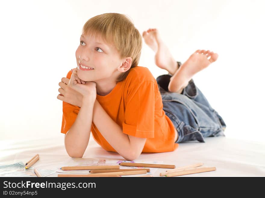 Boy lying on the floor and draw. Boy lying on the floor and draw