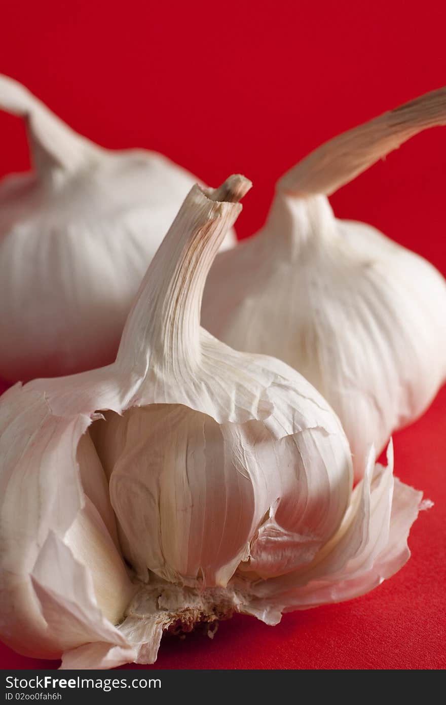 Garlic On Red Background, Half Clove