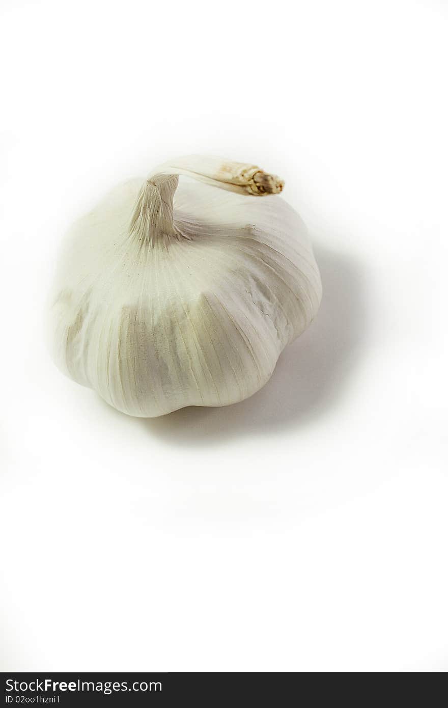 High-key portrait of whole garlic clove from above against white background. High-key portrait of whole garlic clove from above against white background