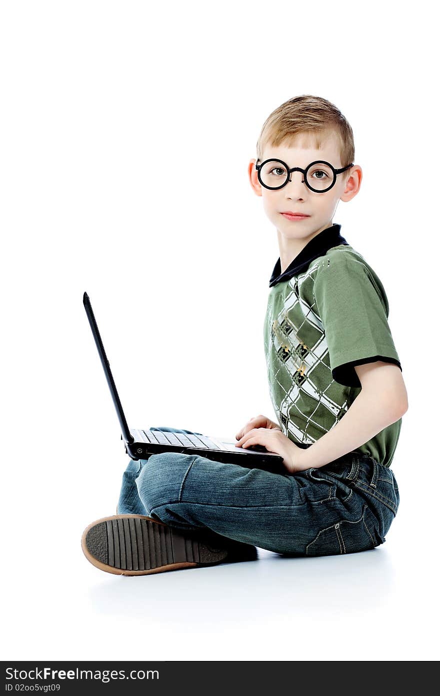 Shot of a boy sitting with his laptop. Isolated over white background. Shot of a boy sitting with his laptop. Isolated over white background.