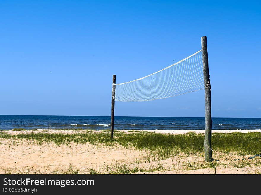 Volleyball net at the empty wild seashore. Volleyball net at the empty wild seashore