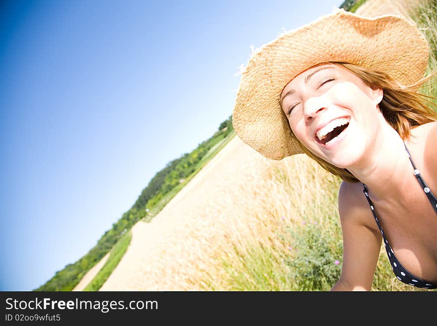 Young woman laughing on a summer day