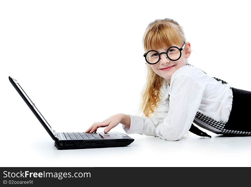 Shot of a little girl lying on a floor with her laptop. Isolated over white background. Shot of a little girl lying on a floor with her laptop. Isolated over white background.