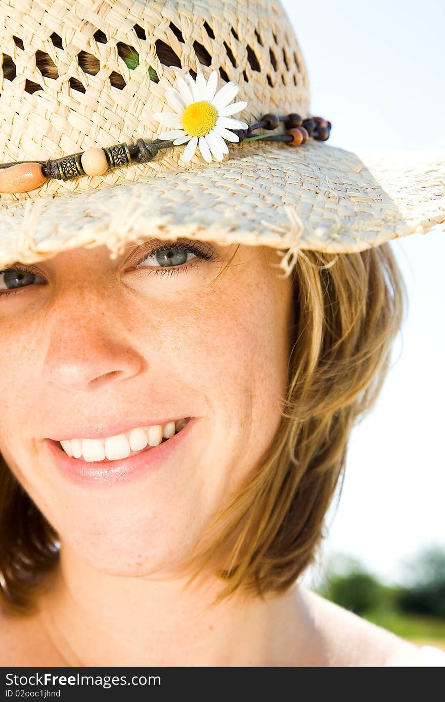 Young woman with hat is smiling. Young woman with hat is smiling