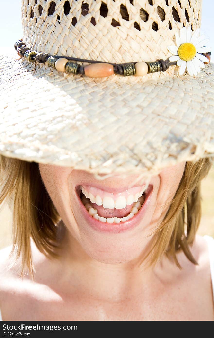 Young woman with hat is smiling. Young woman with hat is smiling