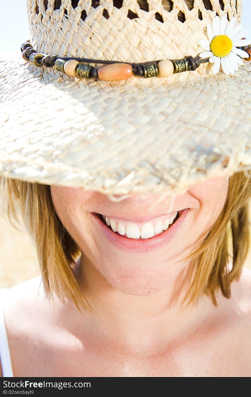 Young woman with hat is smiling. Young woman with hat is smiling