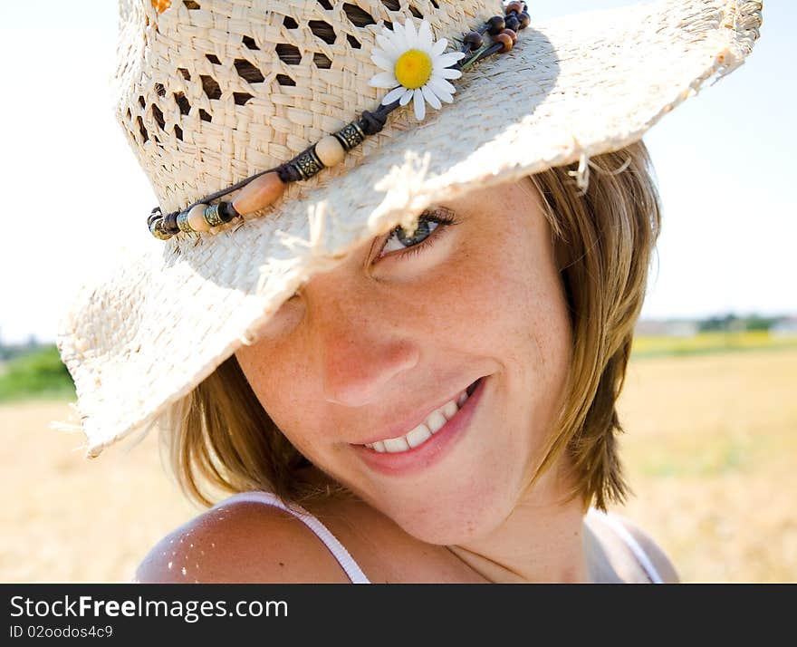 Young happy woman in summer with hat. Young happy woman in summer with hat