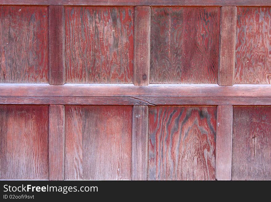 Weathered red wooden garage door background. Weathered red wooden garage door background