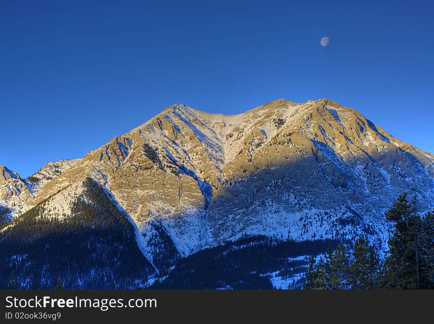 HDR Rocky Mountain with moon just before sunset