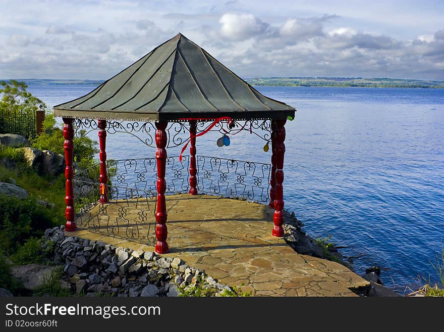 This is a beautiful landscape with a gazebo, in which was a celebration.