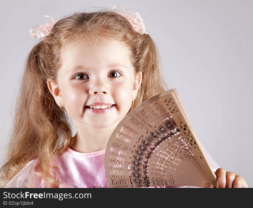 Portrait of beautiful young girl with fan