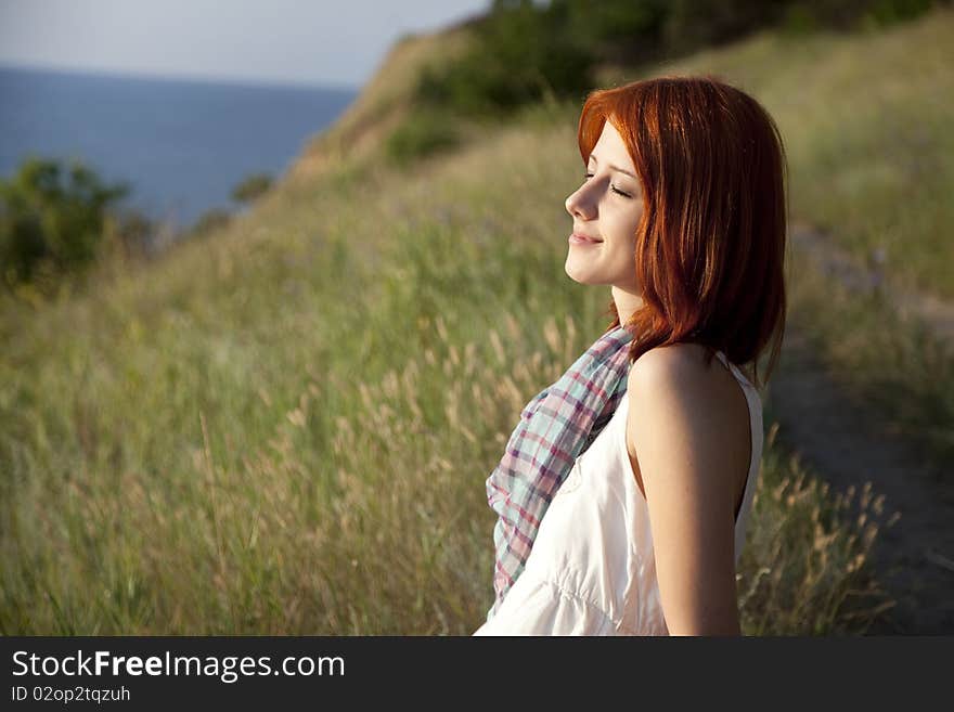 Girl at hill in sunrise. Outdoor photo.