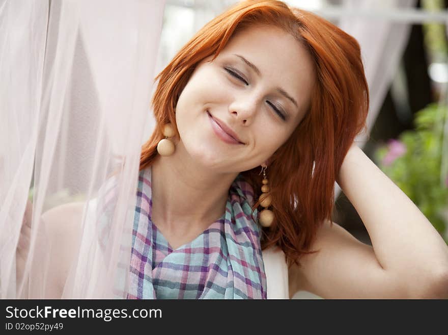 Portrait of beautiful red-haired girl at outdoor. Portrait of beautiful red-haired girl at outdoor.