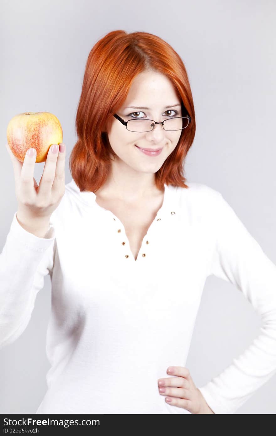 Girl with apple in hand. Studio shot.