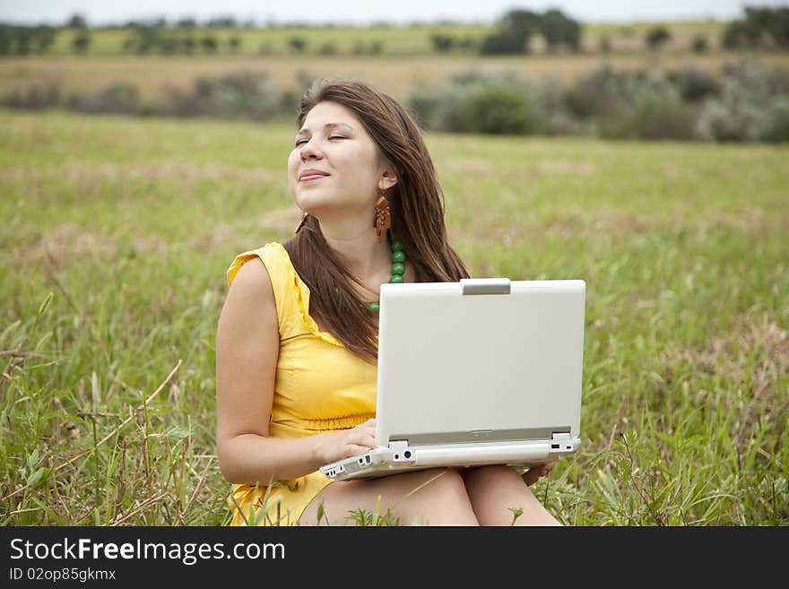 Young beautiful girl with notebook at field