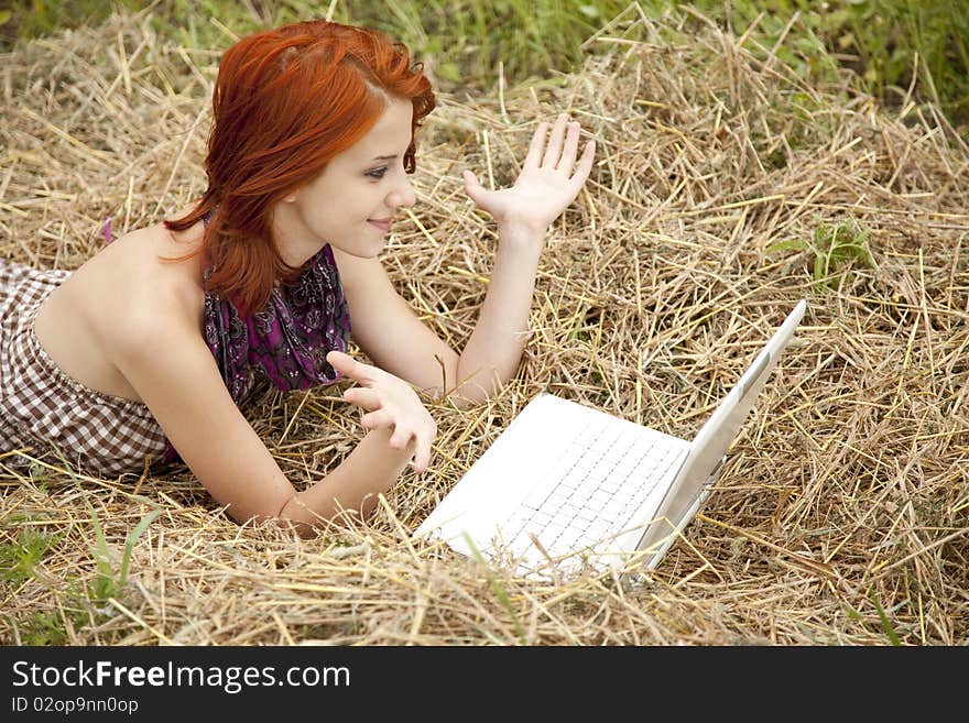 Young fashion girl with notebook lying at field. Outdoor shot. Young fashion girl with notebook lying at field. Outdoor shot.